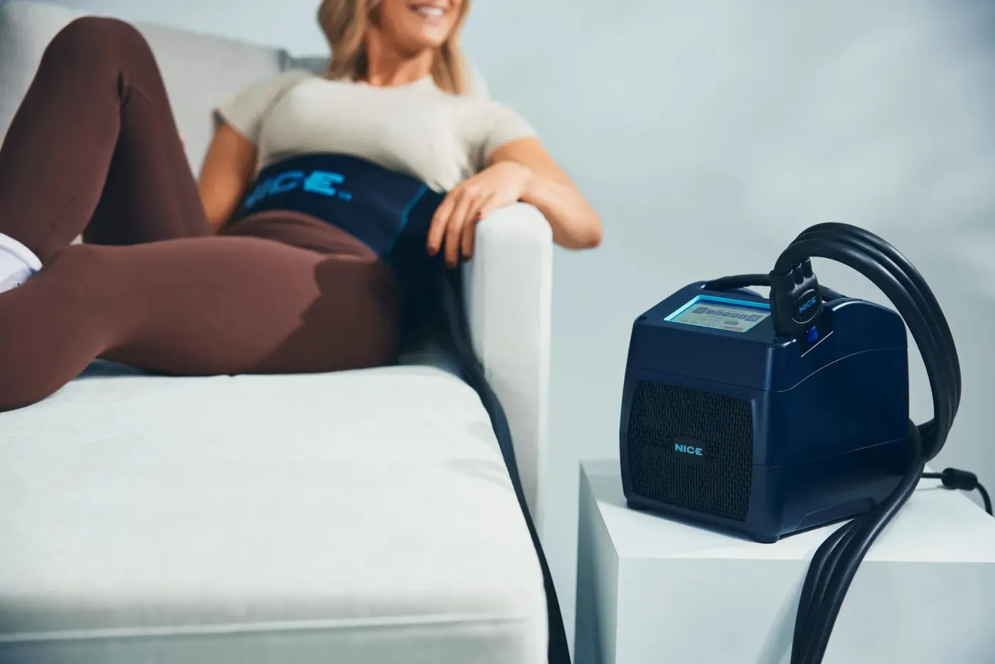 The NICE1 in use at home, wrap on the knee, unit within reach